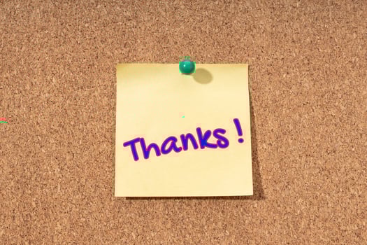 Thanks word on yellow note on cork board photo