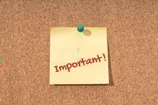Important word on yellow note on cork board photo