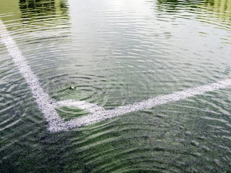 Flooding in artificial grass football field photo