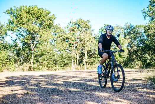 The man riding a bike in a mountain path photo