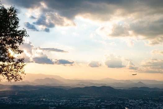 The Sun is falling behind the mountain and city photo