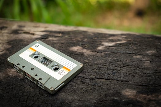 Compact cassette on table background photo