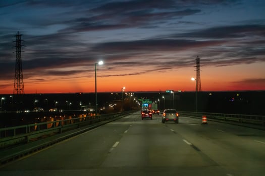 driving over a bridge early morning at sunriseac photo
