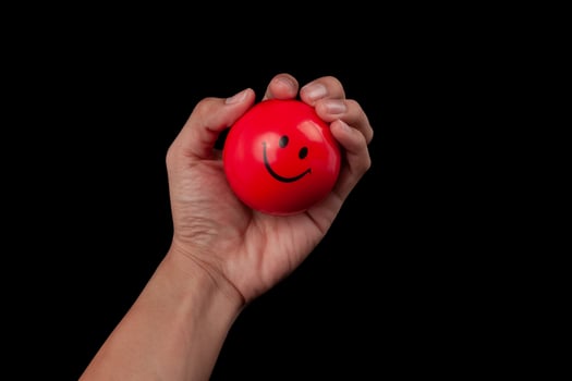 Hand holding stress ball photo