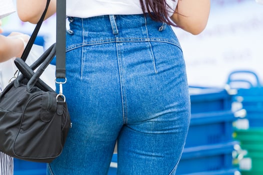 close-up sexy woman in blue jeans with black handbag, copyspace photo