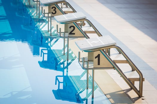 A Row Of Swimming Pool Starting Blocks At The pool Edge. Horizontal photo