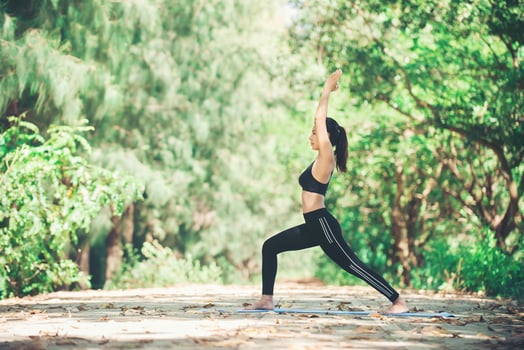 Young asian woman doing yoga in the morning at the park. Healthy photo