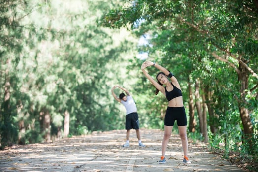 Man and woman stretching together at the park. photo