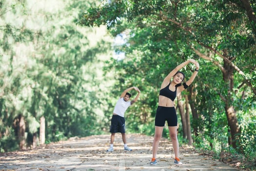 Man and woman stretching together at the park. photo