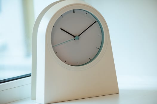 A white modern clock close up photo