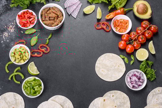 Mexican tacos with beef, tomatoes, avocado, onion and salsa sauce photo