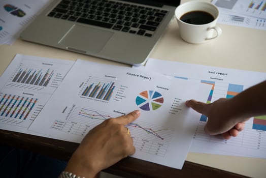 Businessman and woman discussing on stock market charts in office. photo