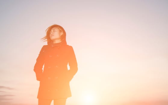 portrait of sad woman standing alone with sunset so lonely photo
