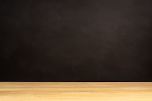 Blank blackboard and wooden table. Empty background. Copy space photo