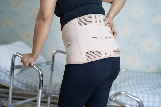 Asian lady patient wearing back pain support photo