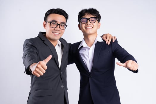 Two Asian business men shoulder to shoulder on a white background photo