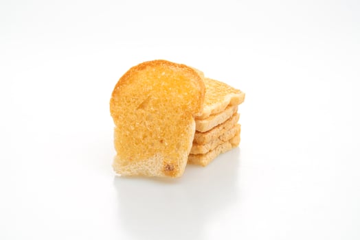 Baked crispy bread with butter and sugar isolated on white background photo