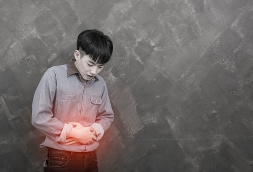 Young handsome man suffering from stomach ache photo