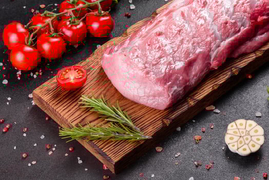 Fresh pieces pork ready to cook on a dark background in the kitchen photo
