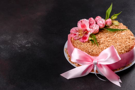 Fresh delicious cake napoleon with cream on a dark background photo