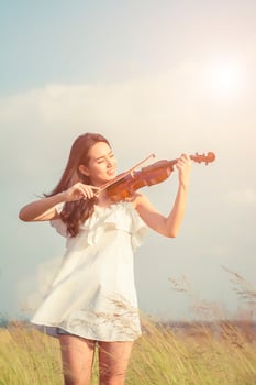 Beautiful women enjoy playing violin photo