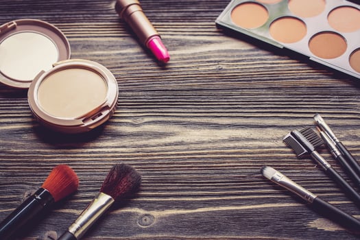 Top view a collection of cosmetic makeup on wooden table photo