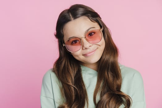Cute, beautiful cute teen girl posing on a pink background photo