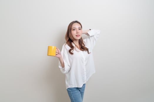 Portrait beautiful Asian woman holding coffee cup or mug on white background photo