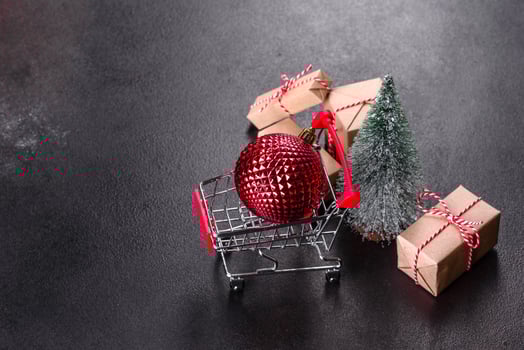 Shopping cart with Christmas gifts and holiday presents photo