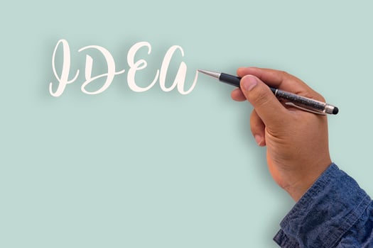 Businessman's hand writing text idea photo