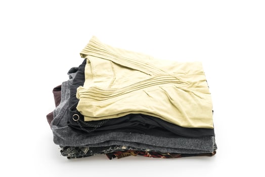 Stacks of clothing on white background photo