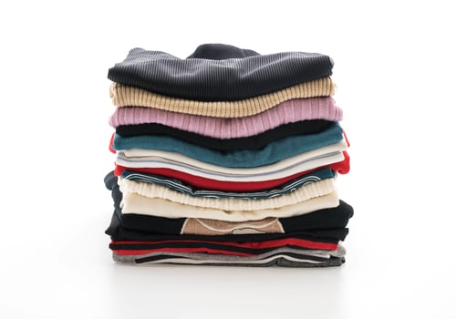 Stacks of clothing on white background photo