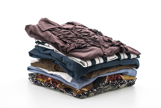 Stacks of clothing on white background photo