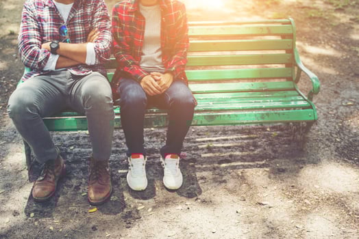 Young teenagers couple in love sitting together on the bench photo