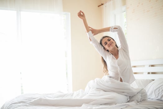 Lazy young woman sitting in bedroom photo