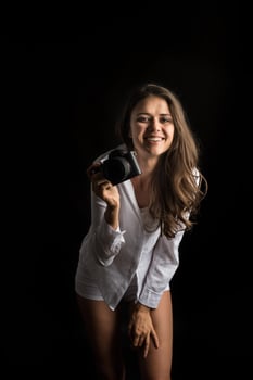 Fashion portrait of young woman photographer with camera photo
