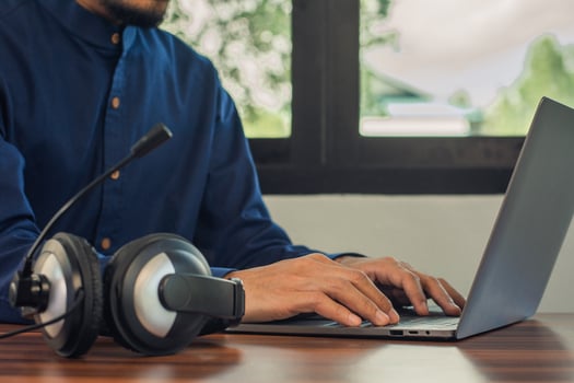 Man are call center headphone online support at home photo