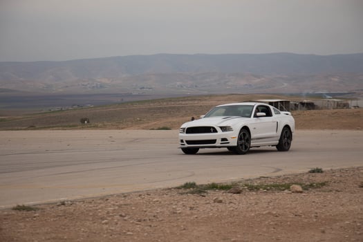 Cars on the race track and on the roads of the desert photo