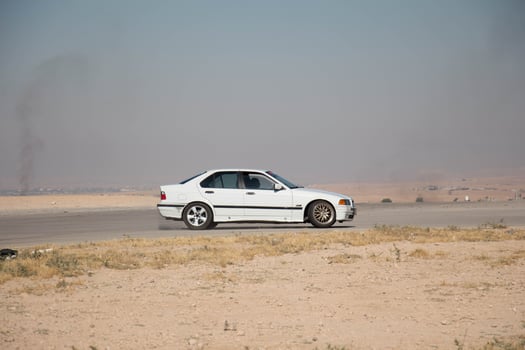 Cars on the race track and on the roads of the desert photo
