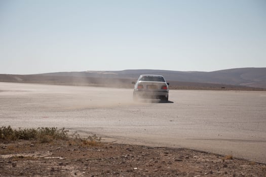 Cars on the race track and on the roads of the desert photo