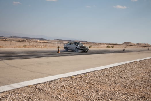 Cars on the race track and on the roads of the desert photo