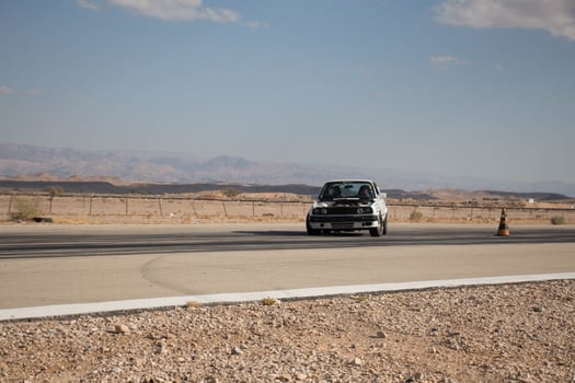 Cars on the race track and on the roads of the desert photo