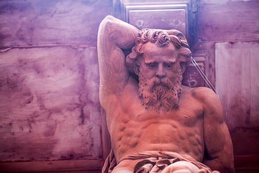 Greek God Statue on a Brick Building photo