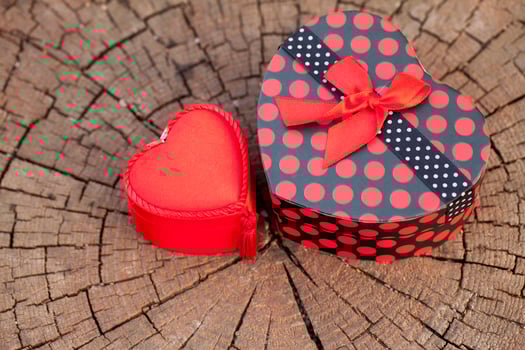 Heart Shape of Gift Box on Wood Trunk photo
