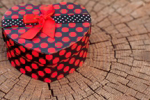 Heart Shape of Gift Box on Wood Trunk photo