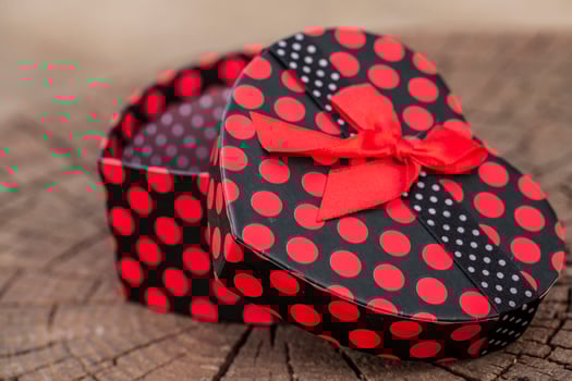Heart Shape of Gift Box on Wood Trunk photo