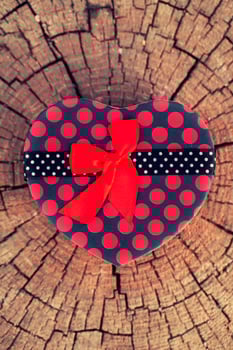 Heart Shape of Gift Box on Wood Trunk photo