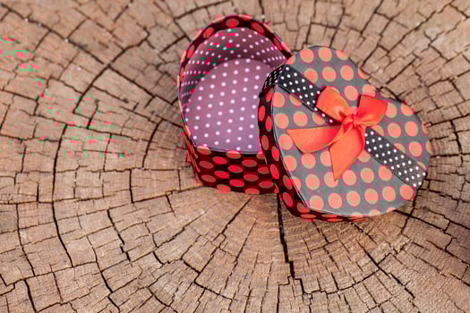 Heart Shape of Gift Box on Wood Trunk photo