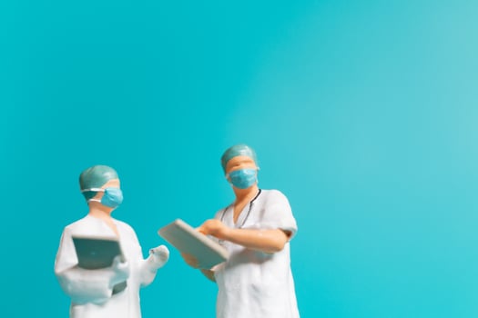 Miniature people A medical officer in a protective uniform photo