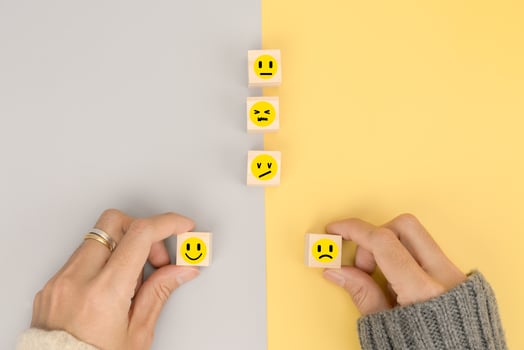 Hand of customer chooses emotion for feedback in business photo